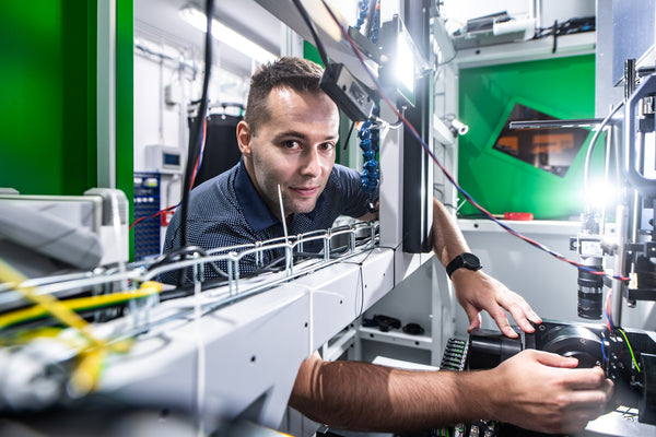 Petr Hauschwitz working beside laser laboratory equipment